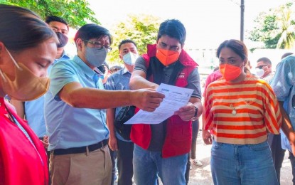 <p><strong>INSPECTION.</strong> President Ferdinand Marcos Jr. (2nd from left) reads the situational briefing during his visit to Abra province on Thursday (July 28, 2022). The province is under a state of calamity following a magnitude 7 earthquake on Wednesday (July 28). <em>(BBM Facebook photo)</em></p>