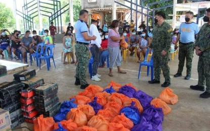 <p><strong>POLICE ASSISTANCE.</strong> Members of the Philippine National Police-Cordillera distribute food packs for residents of Sta. Rosa, Licpan, Bacsil Angad, and Macray villages in Bangued, Abra on Saturday (July 30, 2022). Brig. Gen. Ronald Lee, Regional Director, said the Abra Provincial Police Office, Regional Pastoral Office Cordillera, and Bureau of Fire Protection joined them in assisting families affected by the July 27 earthquake. <em>(Photo courtesy of PCADG Cordillera)</em></p>