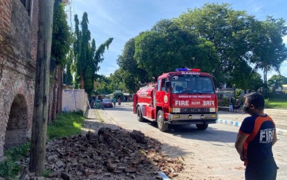 <p><strong>DAMAGED INFRA</strong>. Bricks fall from a century-old building within the Badoc church compound in Ilocos Norte. The July 27, 2022 earthquake damage to Ilocos infrastructure has reached over PHP136 million. <em>(Photo courtesy of BFP Badoc)</em></p>