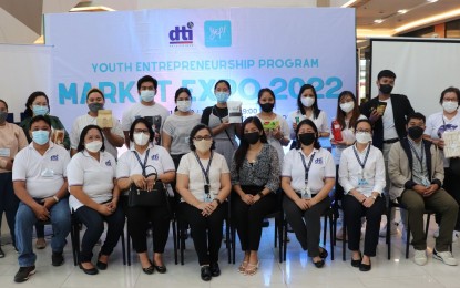 <p><strong>STARTING THEM YOUNG</strong>. Department of Trade and Industry (DTI) officials and beneficiaries of Youth Entrepreneurship Program (YEP) hold their products during a trade fair on July 31, 2022 in Tacloban City. Some 23 small young businessmen from different parts of Eastern Visayas completed DTI’s YEP this year. <em>(Photo courtesy of DTI)</em></p>