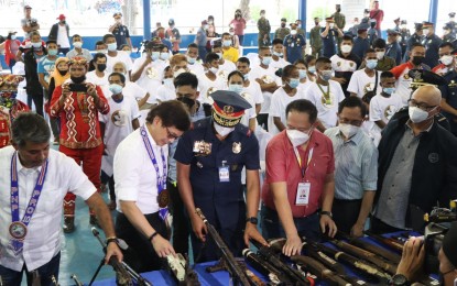 <p><strong>ANTI-INSURGENCY.</strong> Interior and Local Government Secretary Benjamin Abalos Jr. (second from left) inspects the firearms surrendered by former communist rebels, which were presented at the Police Regional Office-10 headquarters in Cagayan de Oro City on Wednesday (Aug. 3, 2022). Abalos assures the 'whole of government' framework in tackling the communist insurgency will be retained by the current administration<em>. (Photo courtesy of DILG - 10)</em></p>