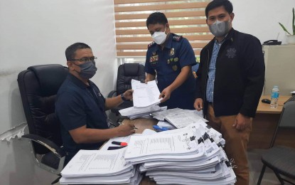 <p><strong>COMPLAINT.</strong> The Masbate Prosecutor's Office receives on Thursday (Aug. 4, 2022) the complaint filed by Col. Rayan Ador, Regional Investigation and Detective Management Division chief (center) and Col. Edwin Engay, Regional Legal Service chief (right), against 21 police officers of the 503rd Maneuver Platoon, Regional Mobile Force Battalion 5 who were said to be involved in the alleged hazing incident that led to the death of Pat. Jaypee de Guzman Ramores in July. The defendants have been relieved from their post and placed under the custody of RMFB 5 inside Camp Ola in Legazpi City. <em>(Photo courtesy of PRO-5)</em></p>
