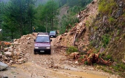 <p><strong>REHABILITATION</strong>. Vehicles negotiate a rocky and muddy road in Abra that was hit by a landslide due to the magnitude 7 earthquake last July 27. The Department of Public Works and Highways in Cordillera said the region needs at least P710 million to rehabilitate the road infrastructure damaged by the tremor. <em>(PNA photo from the FB of DPWH-CAR)</em></p>