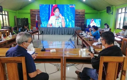 <p><strong>RECOVERY PLAN</strong>. Department of Agriculture in the Cordillera Administrative Region head Cameron Odsey (left) and Assistant Regional Director for Administration Danilo Daguio (right) watch a situation briefing presided over by President Ferdinand Marcos Jr. in Abra on July 28, 2022. DA-CAR officials said they have begun crafting an agriculture recovery plan for the damage to infrastructure, fisheries, livestock, and high-value crop due to the magnitude 7 earthquake.<em> (PNA photo by Jonathan Llanes)</em></p>