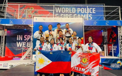 <p><strong>VICTORS</strong>. Members of the Philippine National Police (PNP) taekwondo team triumphantly display the country's and PNP flags and their medals in the 2022 World Police and Fire Games held in Rotterdam, The Netherlands from July 22 to 31, 2022. The team, from the PNP headquarters in Camp Crame, bested the competitions by harvesting 17 gold, 10 silver, and 9 bronze medals.<em> (Photo courtesy of the PNP-PIO)</em></p>