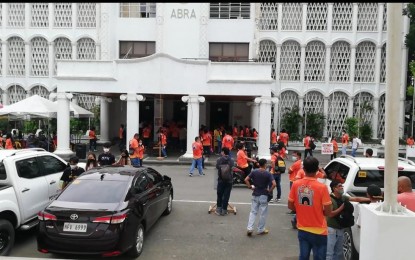 <p><strong>BACK TO NORMAL</strong>. Abra residents have started returning to their homes, livelihood activities and work more than a week after a magnitude 7 earthquake struck the province. Employees are shown in this photo entering the capitol building in Bangued, Abra Monday morning (Aug. 8, 2022). <em>(PNA photo by Liza T. Agoot)</em></p>
