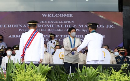 <p><strong>CHANGE OF COMMAND</strong>. President Ferdinand R. Marcos Jr. hands over a saber to the new Armed Forces of the Philippines (AFP) Chief of Staff, Lt. Gen. Bartolome Vicente O. Bacarro, during the change of command ceremony at Camp General Emilio Aguinaldo in Quezon City on Monday (Aug. 8, 2022). Marcos said he sees a stronger AFP under the leadership of Bacarro, who replaced Gen. Andres Centino. <em>(NIB photo by Rey Baniguet)</em></p>