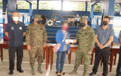 <p><strong>CASH AID</strong>. A former member of the communist terrorist group in Nueva Ecija receives cash assistance in this undated photo. The beneficiary is one of the 43 former rebels who received assistance under the government's Enhanced Comprehensive Local Integration Program (E-CLIP). <em>(Photo courtesy of the Army's 7th Infantry Division)</em></p>
