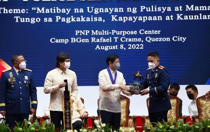 <p><strong>AWARD</strong>. President Ferdinand Marcos Jr. awards the Best Municipal Police Station Award to the San Jose de Buenavista Police Station, represented by Maj. Benjo Clarite (right), during the celebration of the 121st Police Service Anniversary held in Camp Crame on Monday (Aug. 8, 2022). The ceremony was witnessed by (from left) PNP Chief Gen. Rodolfo Azurin Jr. and Interior Secretary Benjamin Abalos Jr. <em>(Photo courtesy of the San Jose de Buenavista Municipal Police Station)</em></p>