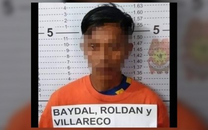 <p><strong>NPA TAX COLLECTOR</strong>. Police arrest a Communist Party of the Philippines-New People's Army (CPP-NPA) rebel and seize from him several weapons in Guihulngan City, Negros Oriental on Monday (Aug. 8, 2022). Roldan Villareco Baydal, 32, was identified as a tax collector of the CPP-NPA's Central Negros 1 guerilla front. <em>(Photo courtesy of the Negros Oriental Provincial Police Office)</em></p>