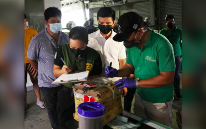 <p><strong>SHABU SHIPMENT.</strong> Zamboanga City Mayor John Dalipe (in white shirt) observes as two Philippine Drug Enforcement Agency (PDEA) operatives conduct an inventory of the PHP3.4 million shabu shipment seized Monday (Aug. 9, 2022) at the Zamboanga International Airport in Zamboanga City. The shabu shipment came from Maluso, Basilan, and was bound to Philcoa, Quezon City. <em>(Photo lifted from the Facebook account of Zamboanga City Mayor John Dalipe)</em></p>