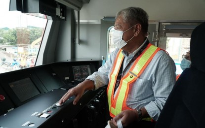 <p><strong>INSPECTION</strong>. Department of Transportation (DOTr) Secretary Jaime Bautista inspects the driver's compartment of one of the new trains of the North-South Commuter Railway on Aug. 11, 2022. Bautista assured that the project will be completed on time, with Contract Package 1 of the project at 31.04 percent complete and Contract Package 2 at 58.81 percent complete. <em>(Photo courtesy of DOTr)</em></p>