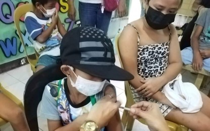 <p><strong>VACCINATED</strong>. A young boy receives the coronavirus disease 2019 (Covid-19) jab in one of the vaccination centers in Bacolod City in July. On Thursday (Aug. 11, 2022), the Bacolod City Health Office strongly advised parents to have their children vaccinated against Covid-19 as a precaution for the opening of classes on August 22. <em>(File photo courtesy Bacolod City Public Information Office)</em></p>