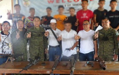 <p><strong>REBELS NO MORE.</strong> Military officials, local leaders, and former Moro extremists pose for a photo opportunity after nine members of the outlawed Bangsamoro Islamic Freedom Fighters (BIFF) yielded to the Army’s 2nd Mechanized Infantry Battalion in Datu Anggal Midtimbang, Maguindanao on Aug. 13, 2022. A day earlier, three Dawlah Islamiya members also surrendered to military authorities in Datu Piang town of the same province. <em>(Photo courtesy of 6ID)</em></p>