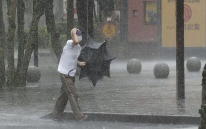 <p>A man walks in heavy rain in the central Japan city of Hamamatsu on Aug. 13, 2022, as Typhoon Meari approaches Japan's Pacific coast close to Tokyo. <em>(Kyodo)</em></p>