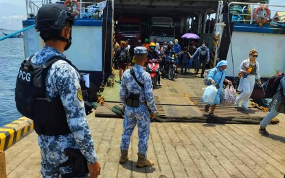 <p><strong>PORT SECURITY.</strong> Personnel of the Philippine Coast Guard monitor disembarking Roll-on Roll-off (RoRo) passengers at a port in Isabela City, Basilan on Aug. 16, 2022. The Philippine Coast Guard will be on heightened alert beginning Friday (Oct. 27, 2023) until Nov. 5, 2023 for the upcoming Barangay and Sangguniang Kabataan elections and All Souls' and All Saints' Days. <em>(Photo courtesy of PCG)</em></p>