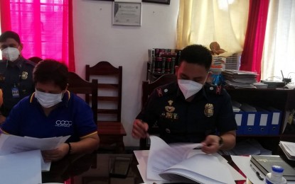 <p><strong>MOA SIGNING</strong>. San Jose Multi-Purpose Cooperative chair Marilou Llavan (left) signs a memorandum of agreement with police chief Lt. Col. Benjo Clarite (right) for their partnership in the community outreach program in Barangay Badiang, San Jose de Buenavista on August 15, 2022. The twice-a-year feeding and gift-giving community outreach program is for the Ati families and their children. <em>(PNA file photo Annabel Consuelo J. Petinglay)</em></p>