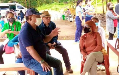 <p><strong>DIPLOMATIC SOLUTION.</strong> Mayor Rogelio Taliño (seated with blue cap) of Carmen, North Cotabato gestures to DAR-12 Regional Director Marianne Lauban-Baunto (seated) after the successful mediation and settlement of land disputes involving three groups in Carmen, North Cotabato on Sunday (Aug. 14, 2022).  At least 109 lots were involved in the decades-old land row. <em>(Photo courtesy of DAR-NoCot)</em></p>