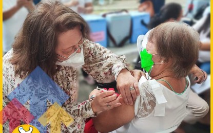 <p><strong>VACCINATED.</strong> Dr. Paula Paz Sydiongco (left), Department of Health Center for Health Development in the Ilocos Region director, inoculates a senior citizen during the launching of ‘Pinaslakas’ in Dagupan City on Aug. 15, 2022. Around 1,000 residents availed of the vaccine following the program launching. <em>(Photo courtesy of DOH-CHD-1)</em></p>