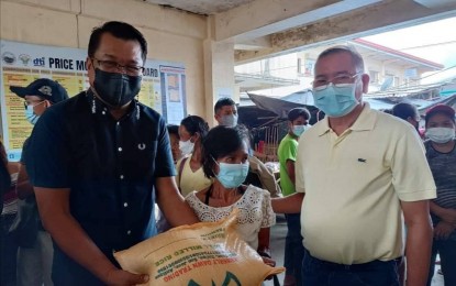 <p><strong>INCENTIVE</strong>. San Remigio Mayor Margarito Mission Jr. (left) and Municipal Councilor Sme Panes (right) show the rice incentive to be given to senior citizens who will submit themselves to vaccination under the PinasLakas campaign, on Wednesday (Aug. 17, 2022). Mission said on Thursday (Aug. 18, 2022) they hope more senior citizens would avail of the vaccination due to the incentive.<em> (Photo courtesy of San Remigio LGU)</em></p>