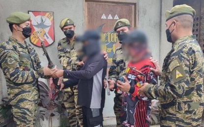 <p><strong>RECONCILIATION.</strong> Officers of the Army’s 5th Special Force Battalion welcome two communist rebels who yield with their firearms Wednesday (Aug. 17, 2022) in Banga, South Cotabato. They turned over two firearms and a hand grenade. <em>(Photo courtesy of 5SFB)</em></p>