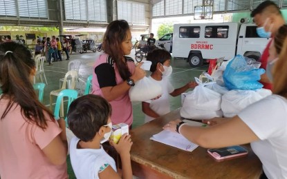 <p><strong>VACCINATED.</strong> Residents in Dagupan City availing of the coronavirus disease 2019 vaccine receive three kilos of rice as an incentive. The city government, through its City Health Office, is bringing the vaccination drive to the villages. <em>(Photo courtesy of City Information Office)</em></p>