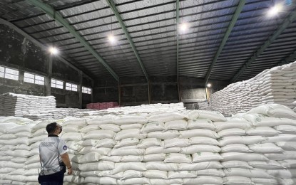 <p><strong>WAREHOUSE INSPECTION</strong>. A BOC official inspects one of the two warehouses in Caloocan City where they discovered sacks of rice and sugar worth PHP231 million. the operation found 66,000 sacks of rice and 13,000 sacks of sugar -- all 50 kilos each -- in the warehouses located in a compound along Deparo Road in Caloocan City on Monday (Aug. 22, 2022). <em>(Photo from BOC) </em></p>