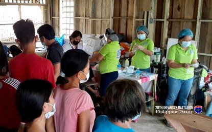 <p><strong>HEALTH SERVICES</strong>. Health workers providing services to residents in a remote village in Las Navas, Northern Samar in this Nov. 21, 2021 photo. The Northern Samar provincial government has asked national government agencies to help in the delivery of Covid-19 vaccines to conflict-affected remote communities to speed up its vaccination program. <em>(Photo courtesy of Philippine Army 20th Infantry Battalion)</em></p>