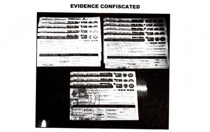<p><strong>FALSIFIED</strong>. Photo shows the confiscated fake vaccination cards allegedly issued by an employee of the city government of Angeles in Pampanga to 13 individuals. The fake vaccination cards contained the falsified signatures and license numbers of the city’s vaccinators. <em>(Photo courtesy of the Angeles City)</em></p>