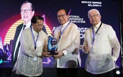 <p><strong>NO COMPLAINTS.</strong> The Employers' Confederations of the Philippines (ECOP) on Friday (June 30, 2023) said it is satisfied with the latest wage order. ECOP president Sergio Ortiz-Luis, Jr. is seen here accepting an award from vice president George Barcelon (middle) and former president Ed Lacson during ECOP's 43rd National Conference last Aug. 24, 2022. <em>(PNA photo by Joey O. Razon)</em></p>