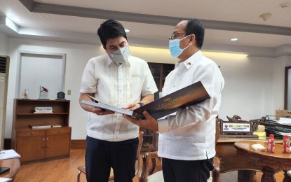 <p><strong>PEACE INITIATIVE</strong>. Presidential Adviser on Peace, Reconciliation and Unity Secretary Carlito G. Galvez Jr. (right) commends Social Welfare Secretary Erwin Tulfo for the latter’s swift approval of the initial PHP287.95 million to help former combatants, during their meeting on Aug. 22, 2022. The social welfare department’s funds will be used for the implementation of sustainable livelihood, modified shelter assistance, and cash-for-work programs for the former rebels and their families.<em> (Photo courtesy of OPAPRU)</em></p>