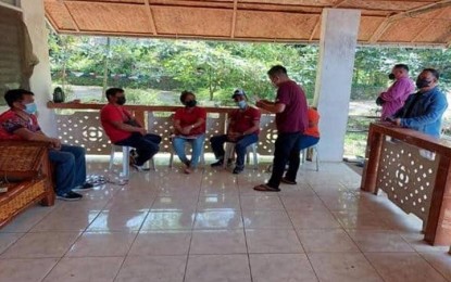 <p><strong>VOTE-BUYING.</strong> Agents of the Criminal Investigation and Detection Group 9 (Zamboanga Peninsula) (standing) serve the arrest warrant against five officials (seated) of Barangay Dulop, Dumingag, Zamboanga del Sur on Thursday (Aug. 25, 2022) for violation of the Omnibus Election Code. The case against the village officials stems from their alleged involvement in vote-buying activities during the May 9, 2022 national and local elections. <em>(Photo courtesy of CIDG-9)</em></p>