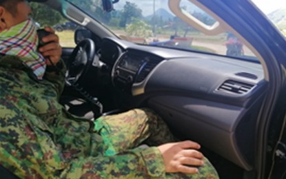 <p><strong>ON DUTY.</strong> A policeman on patrol aboard a police vehicle closely watches for violators of the intensified anti-smoking ban in T’boli, South Cotabato, on Wednesday (Aug. 24, 2022). The T’boli town government has mobilized 100 enforcers for the drive. <em>(Photo courtesy of T’boli MPS)</em></p>