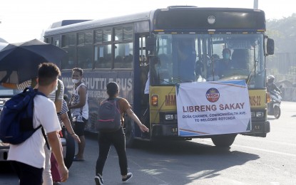 <p><strong>FREE RIDE</strong>. A passenger rushes to get on a shuttle bus offering a free ride along Commonwealth Avenue in Quezon City on Friday (Aug. 26, 2022). The Metropolitan Manila Development Authority has deployed a total of seven buses and two military trucks that will service commuters from Monday to Friday at 6 a.m. to 11 a.m. and 1 p.m. to 6 p.m.<em> (PNA photo by Alfred Frias)</em></p>