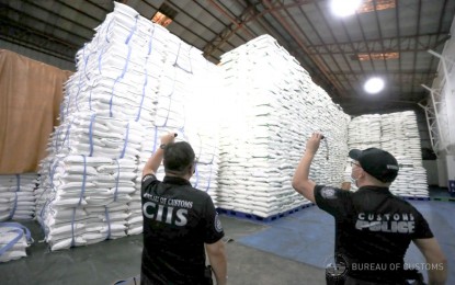<p class="p1"><span class="s1"><strong>ROUTINE CHECK.</strong> Agents of the Bureau of Customs and Enforcement and Security Service - Quick Response Team of the Manila International Container Port inspect the La Perla Sugar Export Corp.’s warehouse along Sgt. Rivera Street in Quezon City on Aug. 23, 2022. No irregular findings were reported about the warehouse that contained 57,000 sacks of imported refined sugar from Thailand valued at PHP285 million. <em>(Photo courtesy of BOC)</em></span></p>