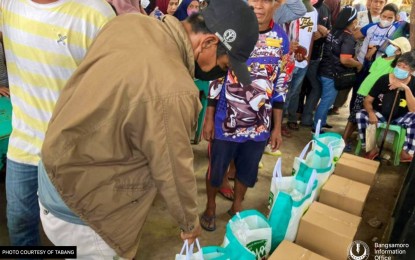 <p><strong>FLOOD AID.</strong> Flood victims in Datu Montawal, Maguindanao, get food and non-food items from the Bangsamoro Autonomous Region in Muslim Mindanao (BARMM) as the region’s relief agency intensified its humanitarian response on Tuesday (Aug. 30, 2022). The BARMM has initially released PHP15 million worth of relief aid to the flood-affected provinces of Maguindanao, the BARMM Special Geographic Area in North Cotabato, and Lanao del Sur. <em>(Photo courtesy of MSSD-BARMM)</em></p>