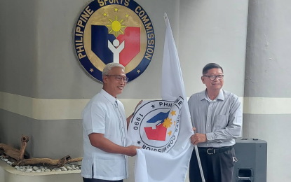 <p>Newly-installed Philippine Sports Commission (PSC) chairman Noli Eala (left) receives PSC flag from former chairman William "Butch" Ramirez during the turnover ceremony at the PSC office inside the Rizal Memorial Sports Complex in Manila on Monday (Sept. 5, 2022). <em>(Photo by Ivan Saldajeno)</em></p>