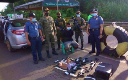 <p><strong>QUESTIONABLE FIREARMS.</strong> Members of Task Force Davao and Toril Police Office arrested Army Pfc. Mohammad Kitig (seated) of the 6th Infantry Division-Civil Military Operation Battalion, after he was flagged down at a Davao City checkpoint in Toril district on Wednesday (Sept. 7, 2022). Seven firearms were found inside the suspect’s vehicle.<em> (Photo courtesy of Toril Police Station)</em></p>