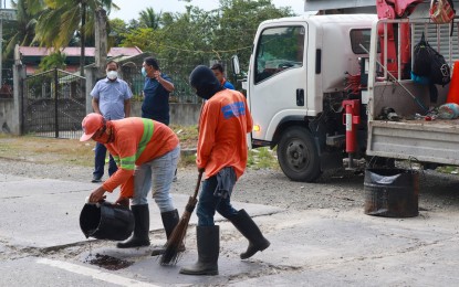 <p><strong>REPAIR. </strong>Personnel of the Department of Public Works and Highways (DPWH) 3 (Central Luzon) repair dilapidated road sections in Nueva Ecija in this undated photo. Defects in various parts of the Cabanatuan City-Carmen and Sta Rosa-Tarlac road sections were caused by the passage of overloaded trucks. <em>(Photo courtesy of DPWH Region 3)<strong> </strong></em></p>