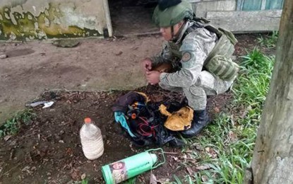 <p><strong>IMPROVISED BOMB</strong>. A member of the Army's 39th Explosive Ordnance Disposal Team disassembles an improvised explosive device (IED) the troops discovered Thursday (Sept. 8, 2022) inside an old school in Barangay Parangbasak, Lamitan City, Basilan. The IED and bomb-making components are believed owned by Basilan-based Abu Sayyaf Group bandits.<em> (Photo courtesy of 101IB)</em></p>