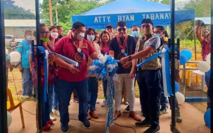 <p><strong>NEW BARANGAY HALLS.</strong> Mayor Armando Quibod (left) of Makilala, North Cotabato, cuts the ribbon for the ceremonial opening of a new village hall for Barangay Sto. Niño in the town on Friday (Sept. 9, 2022). On the same day, 13 other barangays got new village halls that were turned over by representatives of the Office of Civil Defense and the Department of Public Works and Highways. <em>(Photo courtesy of Makilala LGU)</em></p>