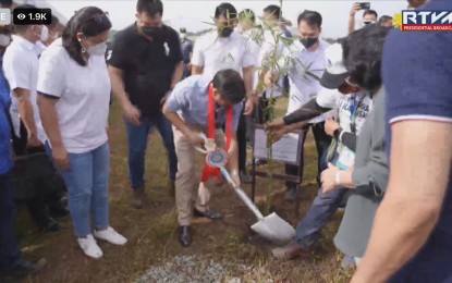 <p><strong>MEANINGFUL BIRTHDAY.</strong> President Ferdinand Marcos Jr. plants a bamboo plant stock at the former sanitary landfill at Pintong Bukawe in San Mateo, Rizal on Tuesday (Sept. 13, 2022) morning, which coincides with his 65th birthday. The program aims to plant over 8,000 seedlings and bamboo planting stocks in some parts of Calabarzon.<em> (Screengrab from RTVM)</em></p>