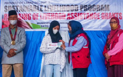<p><strong>BARMM CARES.</strong> Lawyer Raissa Jajurie, minister of the Bangsamoro Autonomous Region in Muslim Mindanao’s Ministry of Social Services and Development, hands over cash assistance to one of the orphans in Lanao del Sur on Tuesday (Sept. 13, 2022). At least 1,447 indigents have received financial assistance from the regional government to pursue economic and educational interests. <em>(Photo courtesy of MSSD-BARMM)</em></p>