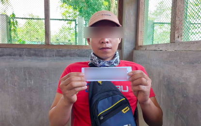 <p><strong>HOUSING UNIT.</strong> Fritz, 28, an ex-New People's Army (NPA) rebel, shows the unit number of the house provided for free by the National Housing Authority in Davao Region (NHA-11) at Freedom Residences in Barangay Cuambogan Tagum City, Davao del Norte. He is among the rebel surrenderers who joined the raffle for the free houses on Wednesday (Sept. 14, 2022).<em> (Photo courtesy of NHA-11)</em></p>