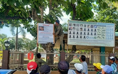 <p><strong>WANTED FOR MURDER</strong>. Troops of the Philippine Army’s 79th Infantry Battalion install a “wanted” poster containing the photograph and personal information of New People’s Army hitman Roger Fabillar, also known as “Arnel Tapang” and “Jhong”, in Calatrava, Negros Occidental on Wednesday (Sept. 14, 2022). The reward money for Fabillar’s capture has been set at PHP500,000.<em> (Photo courtesy of 79th Infantry Battalion, Philippine Army)</em></p>