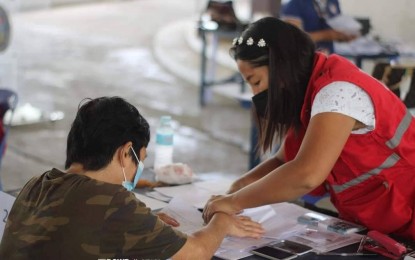 <p><strong>GRANT.</strong> A recipient of the livelihood assistance grant from Dumangas, Iloilo is being assisted by a staff of the Department of Social Welfare and Development during the distribution on Aug. 15, 2022. The department has released PHP223.81 million worth of livelihood assistance grant as part of the coronavirus disease 2019 (Covid-19) response of the department in Iloilo from June 2020 until Sept. 13, 2022. <em>(Photo courtesy of DSWD Western Visayas Facebook page)</em></p>