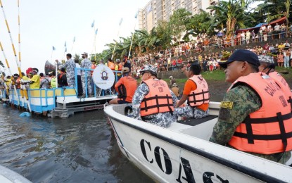 <p><strong>RIVER PROCESSION</strong>. Brig. Gen. Rudolph Dimas (right), director of the Police Regional Office 5, leads the police personnel deployed in Naga City to ensure public safety during the Peñafrancia Festival fluvial procession on Saturday (Sept. 17, 2022). The festivity is considered the biggest religious event in Bicol and is celebrated yearly to honor the feast day of Our Lady of Peñafrancia, patroness of the region.<em> (Photo courtesy of PRO-5) </em></p>