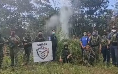 <p><strong>TORCHED MARIJUANA PLANTS.</strong> State forces pose after setting ablaze part of the PHP10 million worth of marijuana plants seized in Barangay Batobato, Maguing, Lanao del Sur, on Saturday (Sept. 17, 2022). Concerned citizens tipped authorities on the existence of the vast marijuana plantation. <em>(Photo courtesy of Lanao del Sur PPO)</em></p>