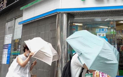 <p><strong>STORMY.</strong> Pedestrians walk under the rain in Tokyo, Japan on Monday (Sept. 19, 2022). Two people were reported dead and another missing after powerful Typhoon Nanmadol landed in the southwestern region of Kyushu. <em>(Courtesy of Xinhua/Zhang Xiaoyu)</em></p>
