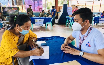 <p><strong>HELPING MIGRANT WORKERS</strong>. A staff of the Overseas Workers Welfare Administration (OWWA) answers queries from a family member of an overseas worker during a caravan in Maasin City, Southern Leyte on Sept. 20, 2022. OWWA is pushing for the establishment of overseas Filipino worker (OFW) help desks in all villages in Eastern Visayas within the year. <em>(OWWA Southern Leyte photo)</em></p>